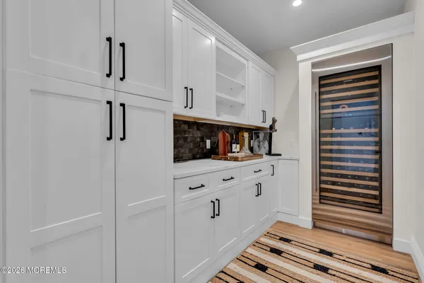 a kitchen with white cabinets and white appliances