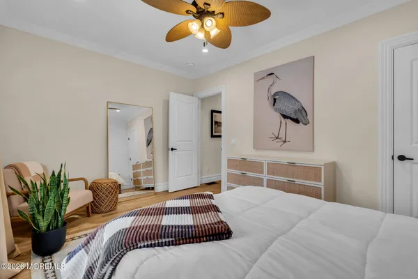 a bedroom with a large bed and a chandelier