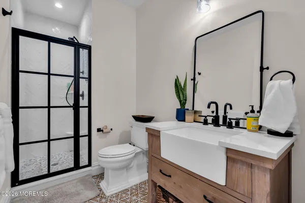 a bathroom with a toilet sink and mirror