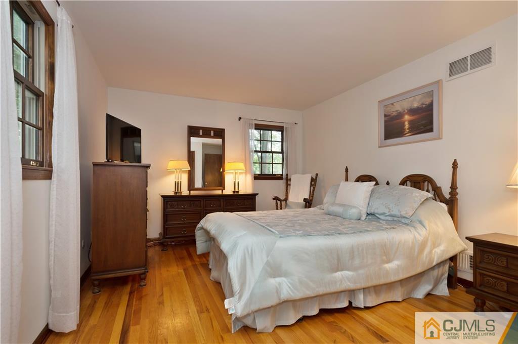 2 Doria Road Somerset, NJ 08873 - Photo 12 of 19 a bedroom with a bed and wooden floor