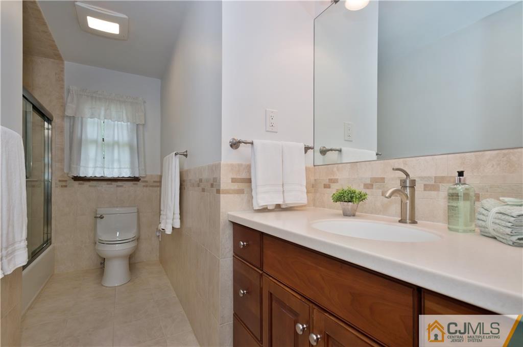 2 Doria Road Somerset, NJ 08873 - Photo 14 of 19 a bathroom with a granite countertop sink and a toilet
