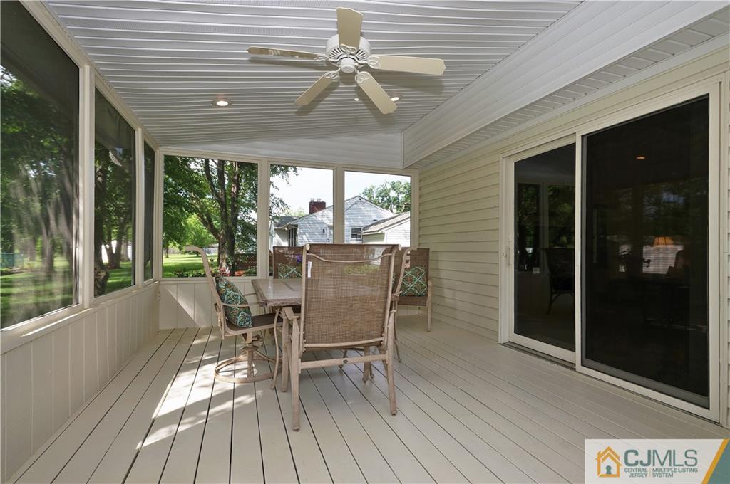 2 Doria Road Somerset, NJ 08873 - Photo 16 of 19 a view of a patio with table and chairs and wooden floor