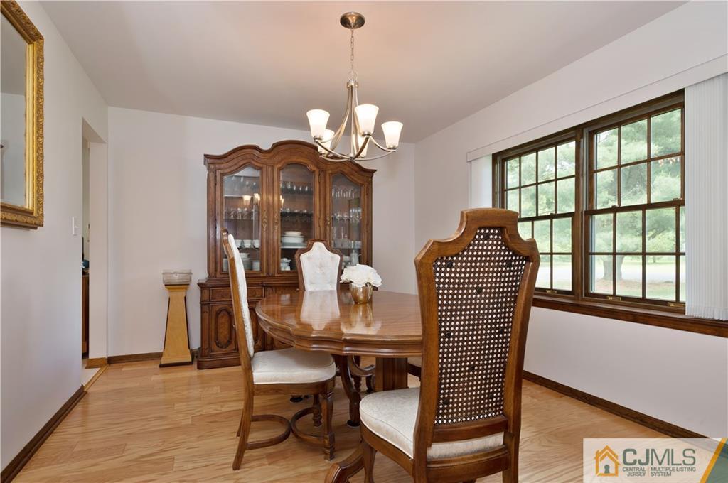 2 Doria Road Somerset, NJ 08873 - Photo 7 of 19 a dining room with furniture a large window and wooden floor