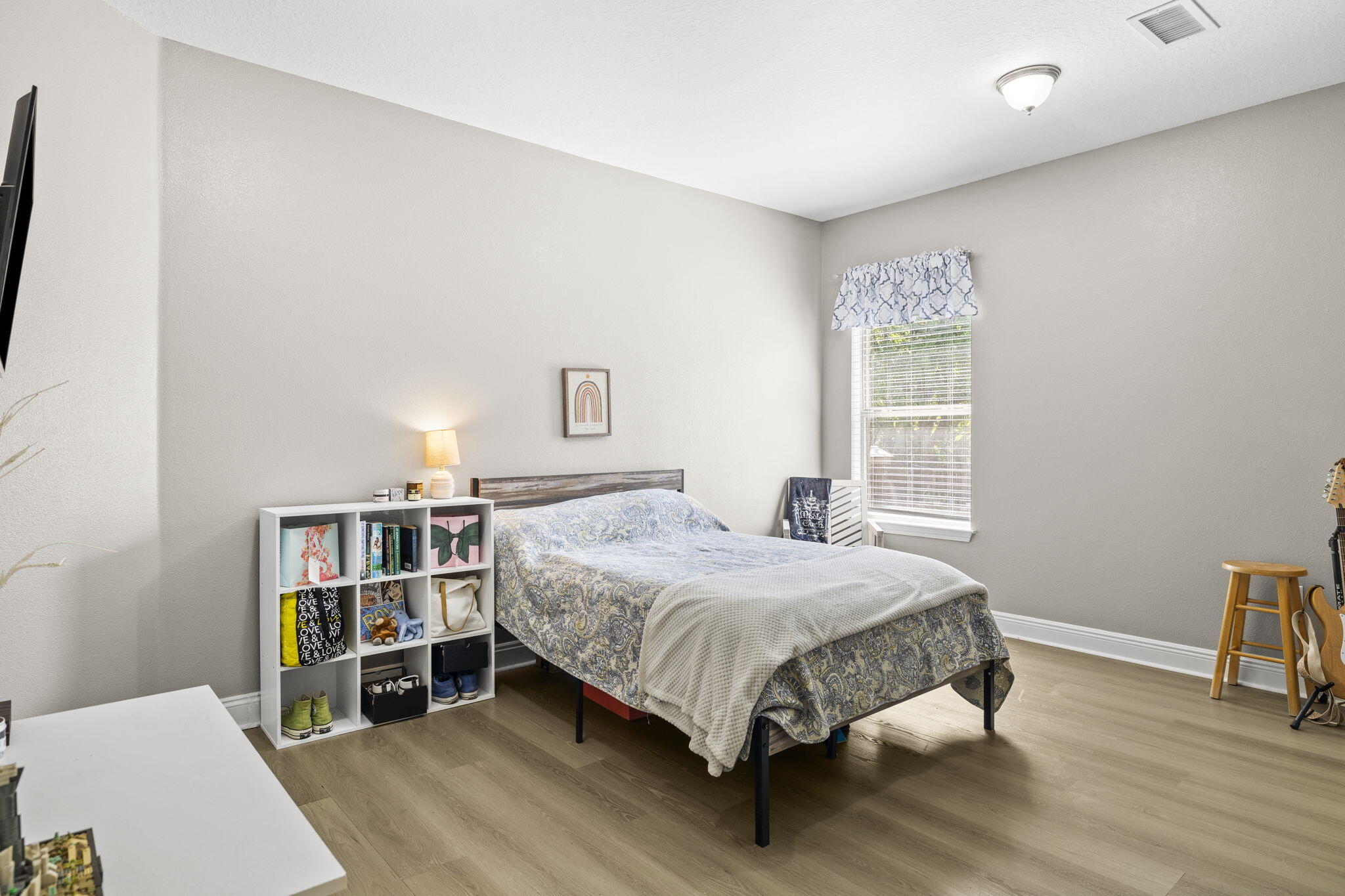 59 Echo Cove Freeport, FL 32439 - Photo 19 of 32 a bedroom with a bed and a bookshelf