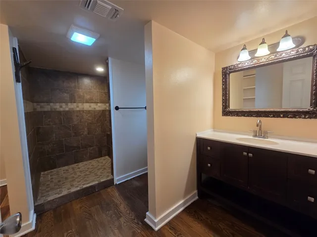 a bathroom with double vanity and a mirror