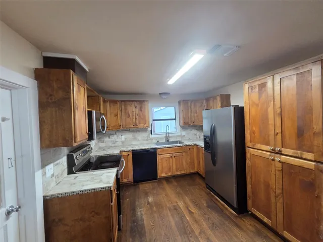 a kitchen with refrigerator and microwave