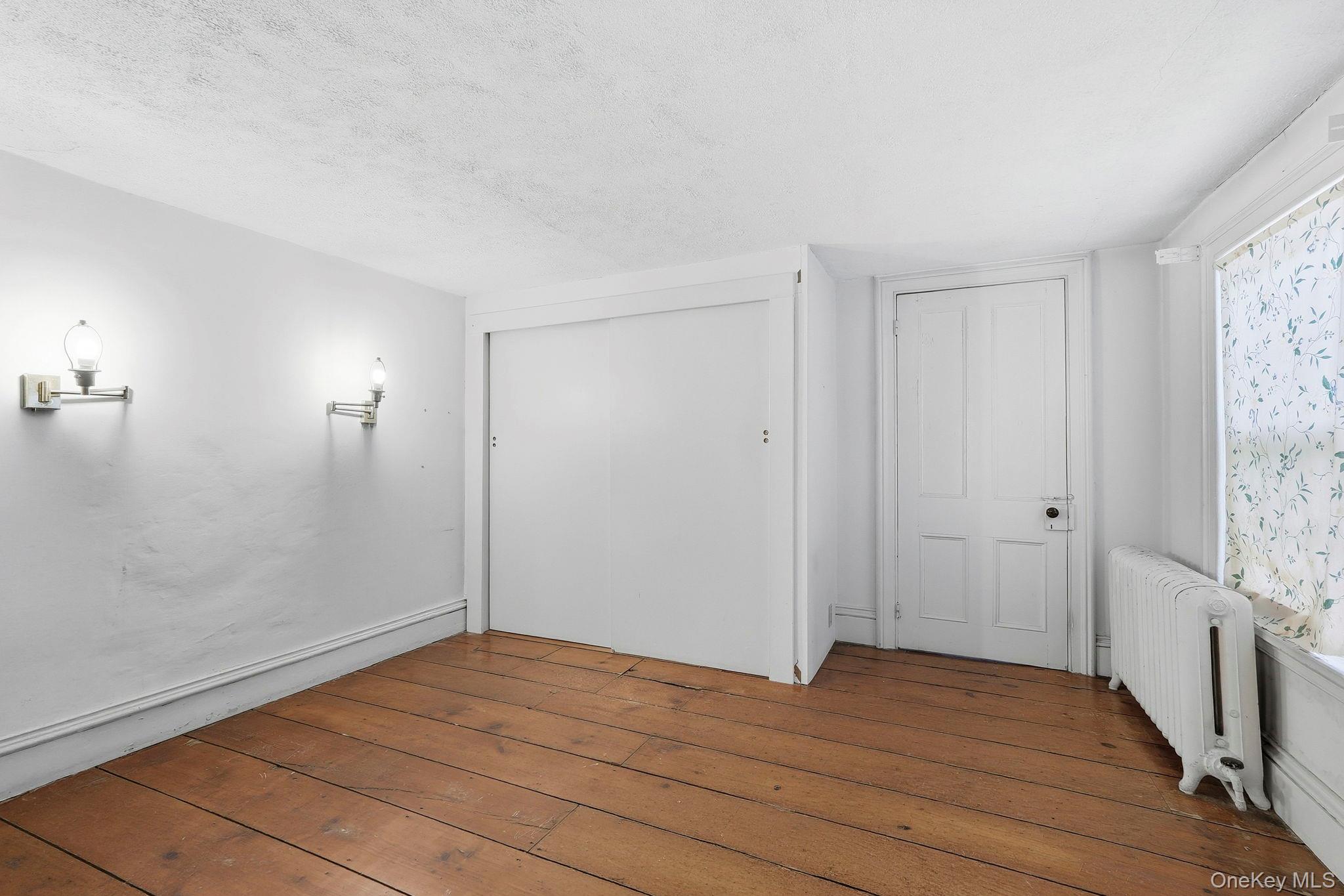 16 Hornbeck Road Poughkeepsie, NY 12603 - Photo 9 of 10 Hardwood plank flooring complements white walls