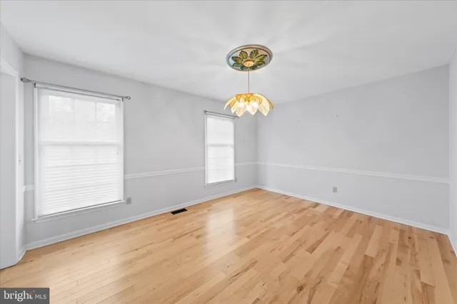 a kitchen with stainless steel appliances granite countertop a stove a sink dishwasher and cabinets with wooden floor