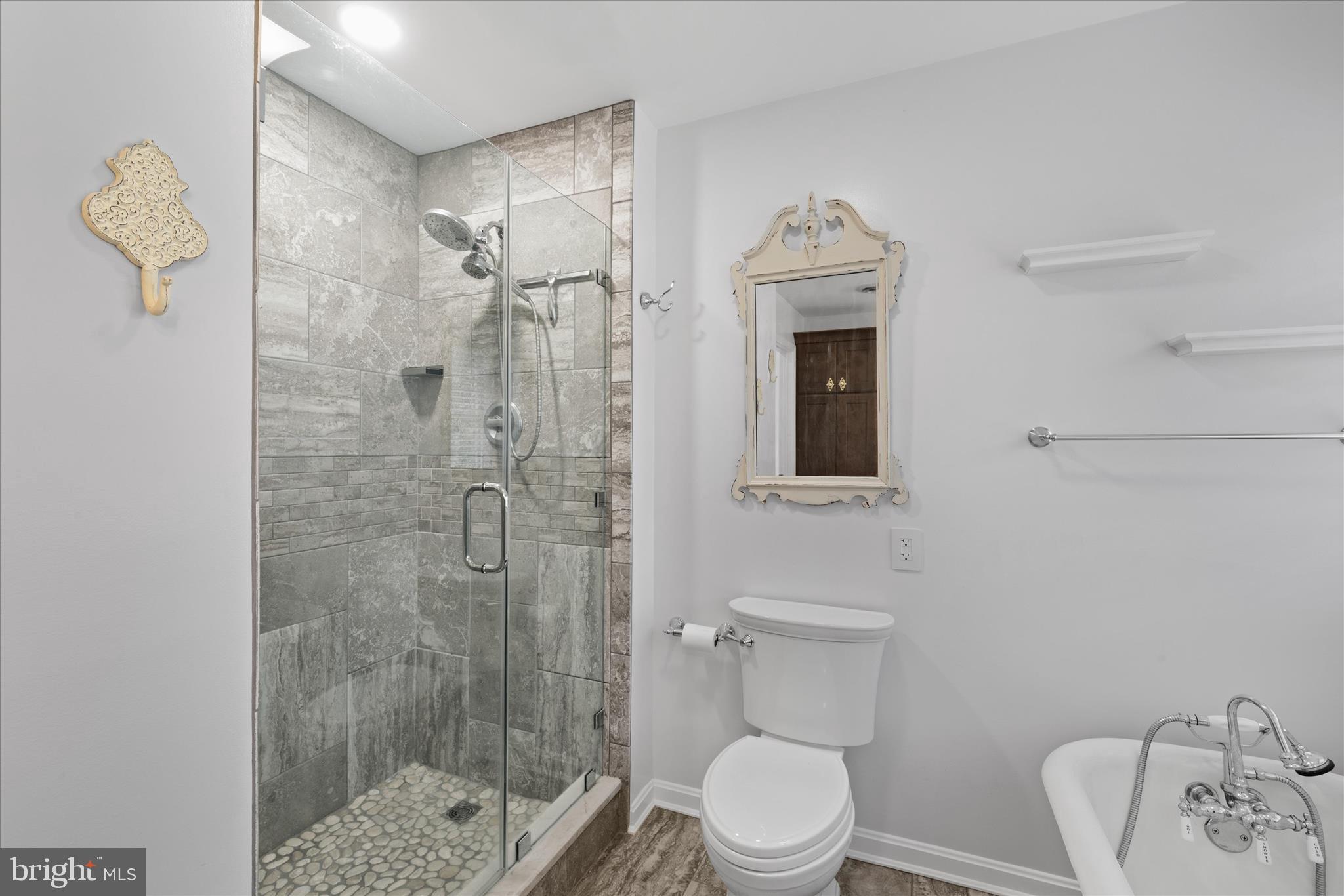 30398 Southampton Bridge Road Salisbury, MD 21804 - Photo 48 of 76 a bathroom with a toilet a sink and shower