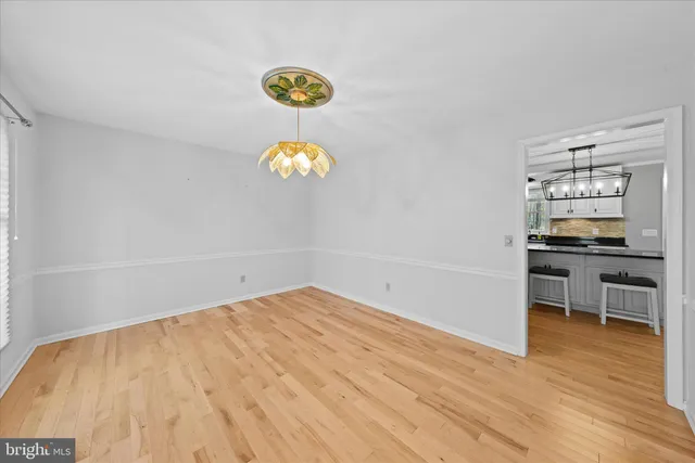 a kitchen with stainless steel appliances granite countertop a refrigerator a stove and a wooden floors