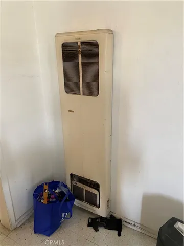 a room with a wooden floor and a mirror