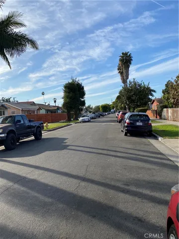 a view of street with parked cars