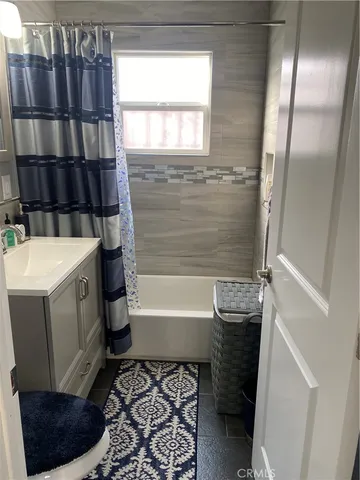 a bathroom with a bathtub sink and window