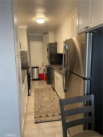 a kitchen with refrigerator and window