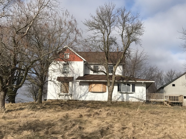 564 Base Line Road Walnut, IL 61376 - Photo 1 of 20 a front view of a house with a yard covered with snow
