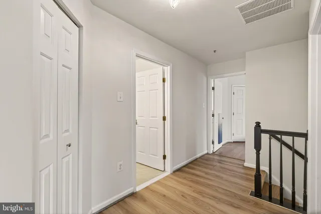 a bedroom with a bed and painting on the wall