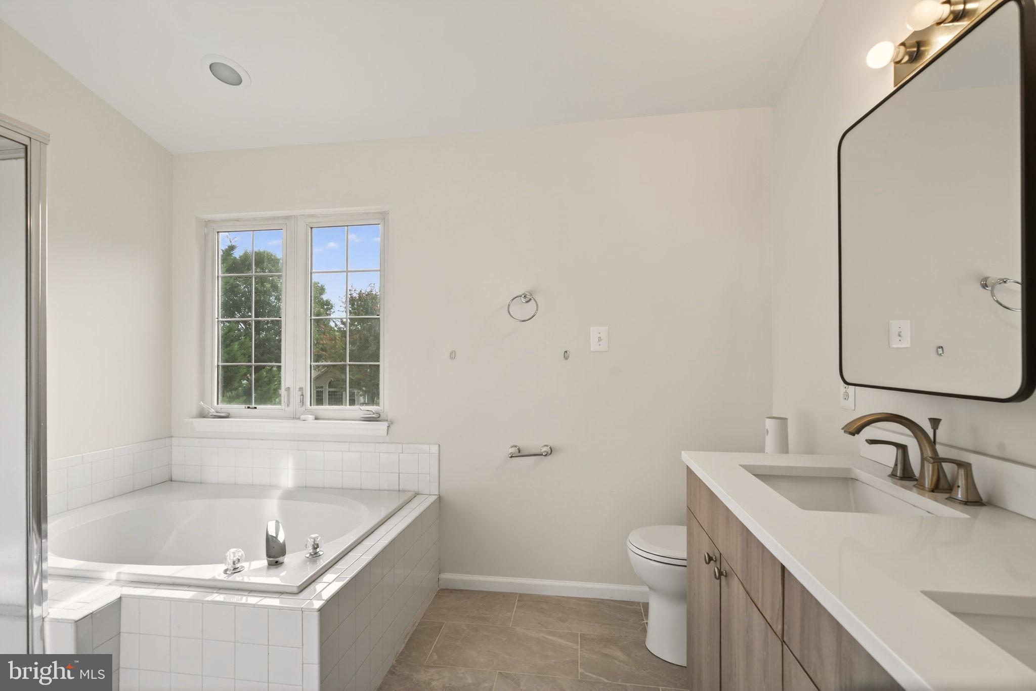6903 Bock Road Fort Washington, MD 20744 - Photo 20 of 62 a bathroom with a sink a toilet and shower