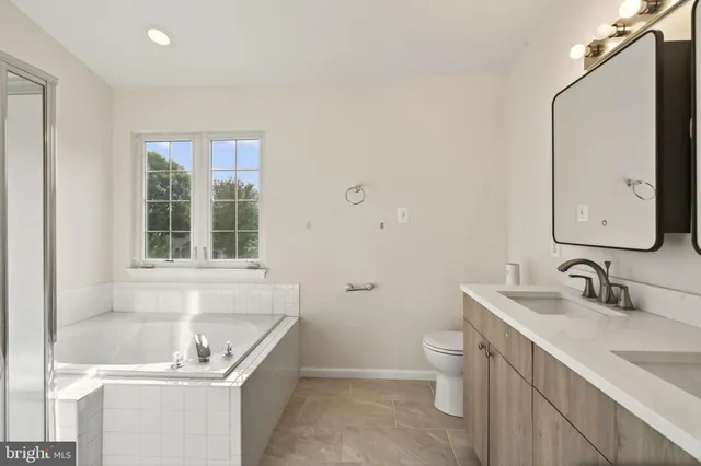 a bathroom with a sink toilet tub and shower