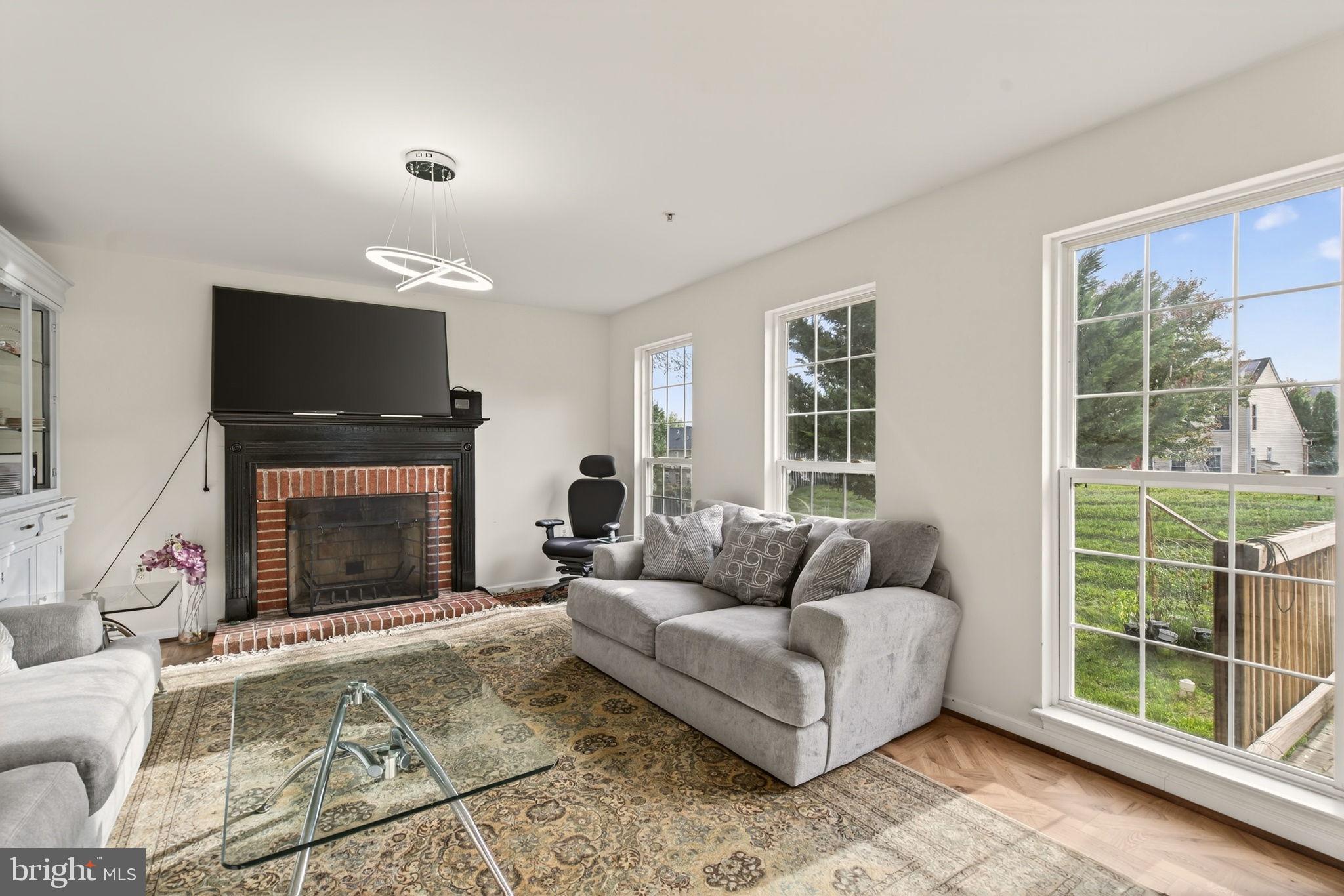 6903 Bock Road Fort Washington, MD 20744 - Photo 45 of 62 a living room with furniture a flat screen tv and a fireplace