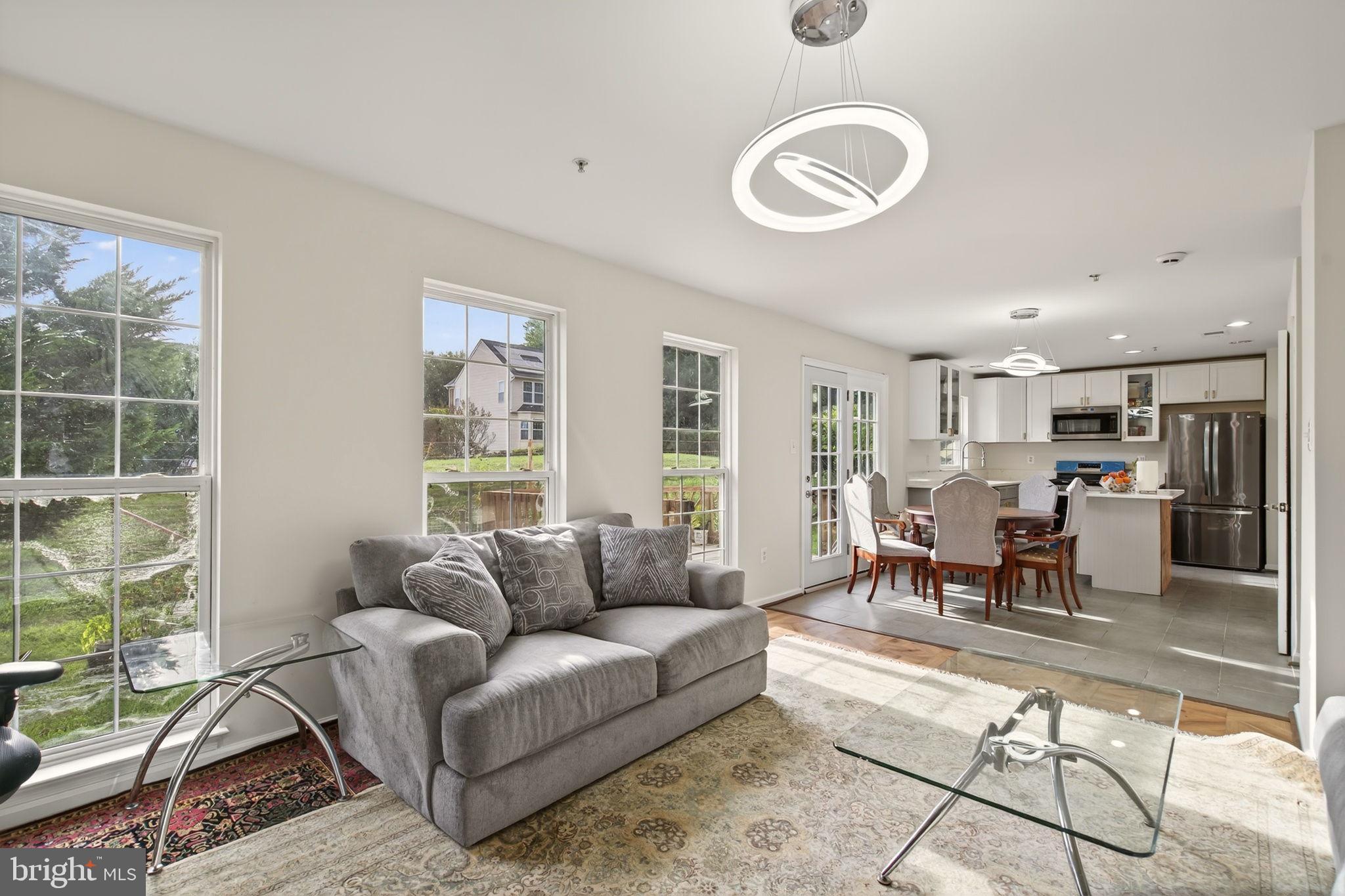 6903 Bock Road Fort Washington, MD 20744 - Photo 46 of 62 a living room with furniture a table and a large window