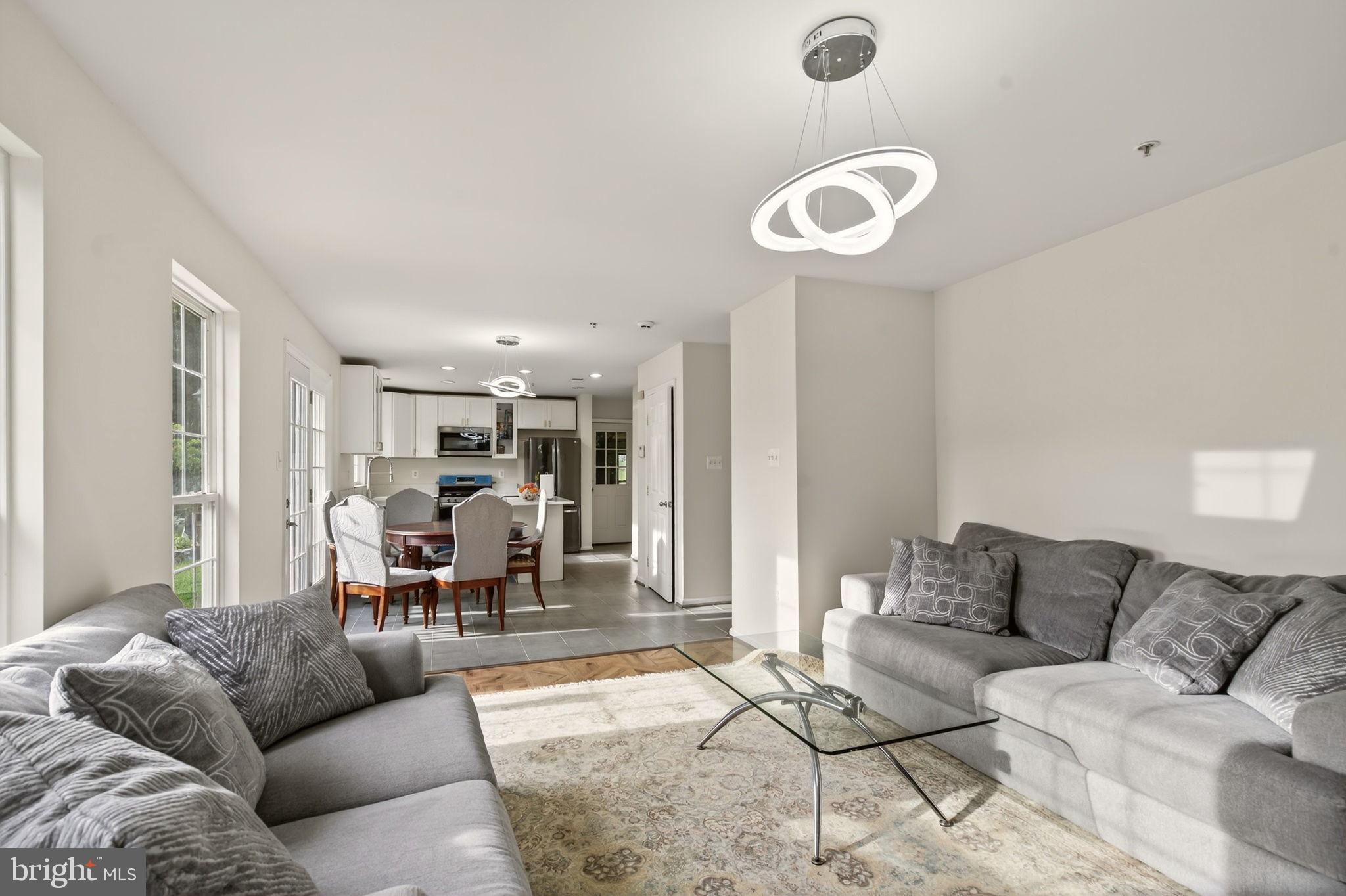 6903 Bock Road Fort Washington, MD 20744 - Photo 47 of 62 a living room with furniture and a chandelier