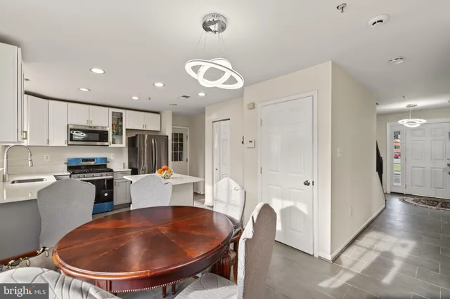 a view of a white house with a yard and a table