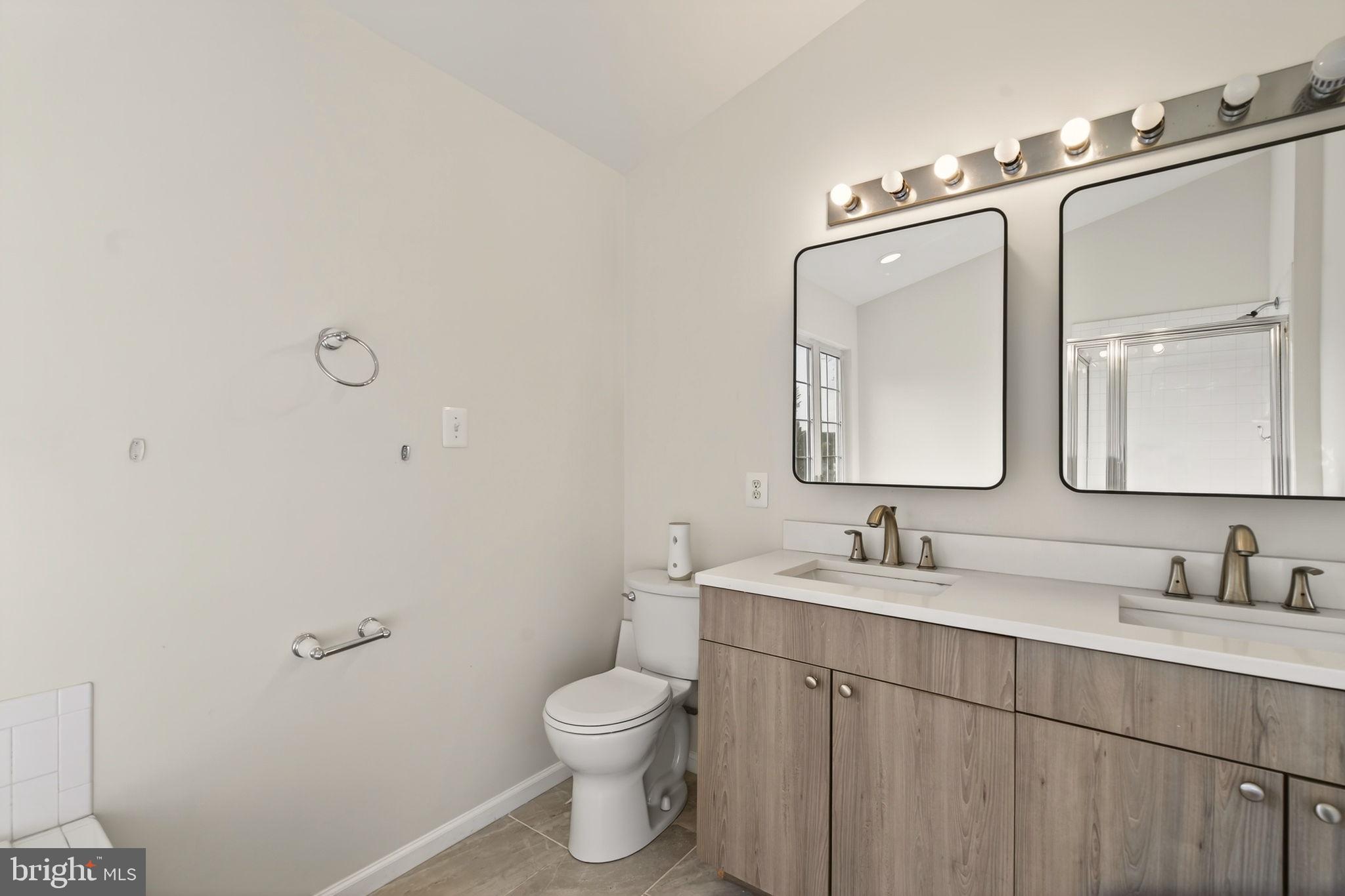 6903 Bock Road Fort Washington, MD 20744 - Photo 60 of 62 a bathroom with a toilet sink double vanity and mirror