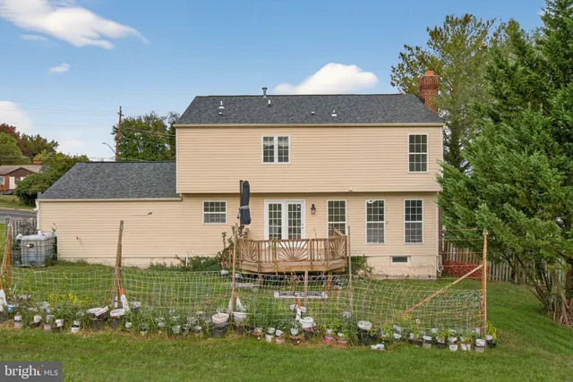 a view of a house with a big yard and potted plants