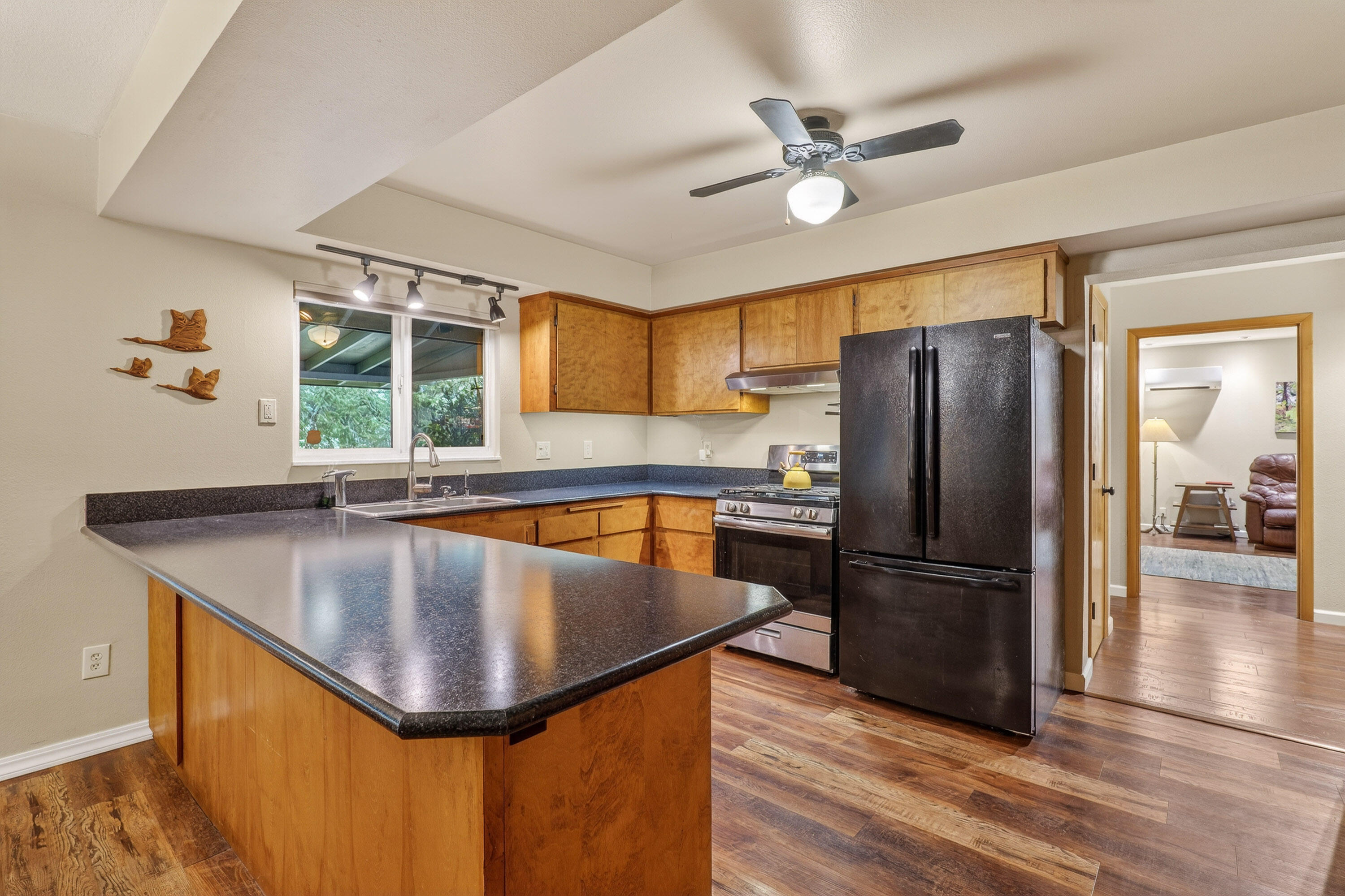 244 Riessen Road Grants Pass, OR 97526 - Photo 12 of 52 a kitchen with stainless steel appliances granite countertop a sink refrigerator and cabinets