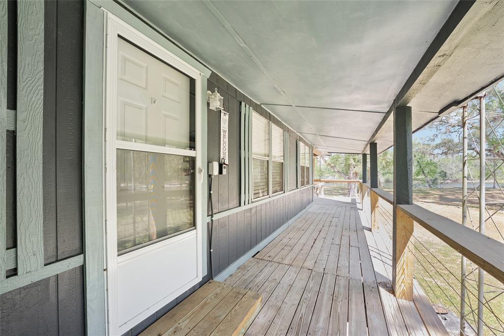 7870 Southwest 25th Place Bell, FL 32619 - Photo 61 of 99 a view of a porch with wooden floor and outdoor space