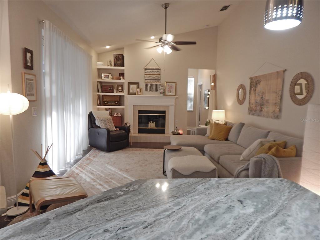 3603 Cypress Meadows Road Tampa, FL 33624 - Photo 11 of 33 a living room with furniture and a fireplace
