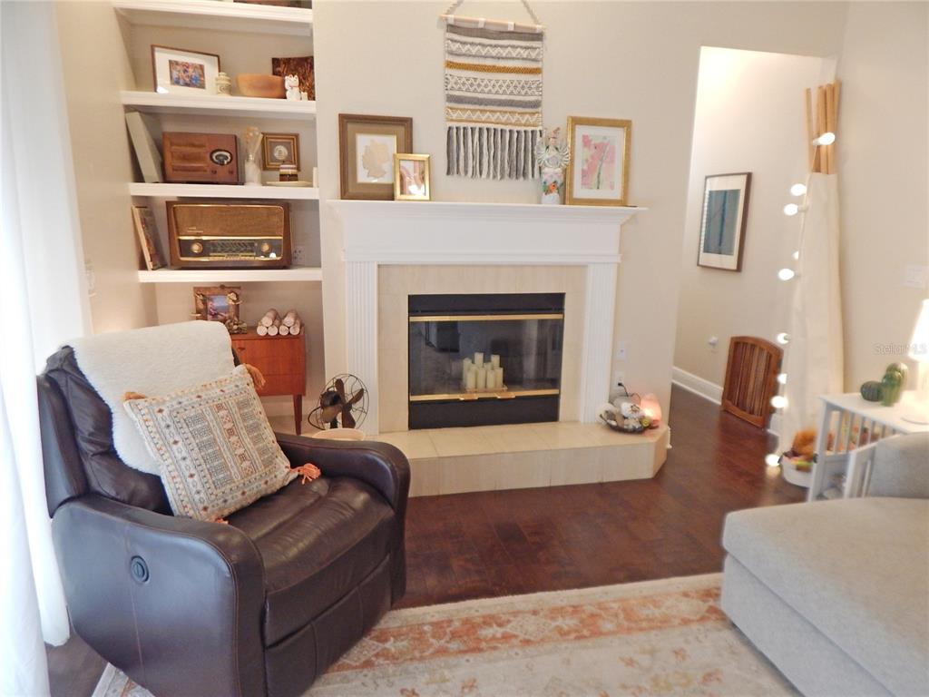 3603 Cypress Meadows Road Tampa, FL 33624 - Photo 12 of 33 a living room with furniture and a fireplace