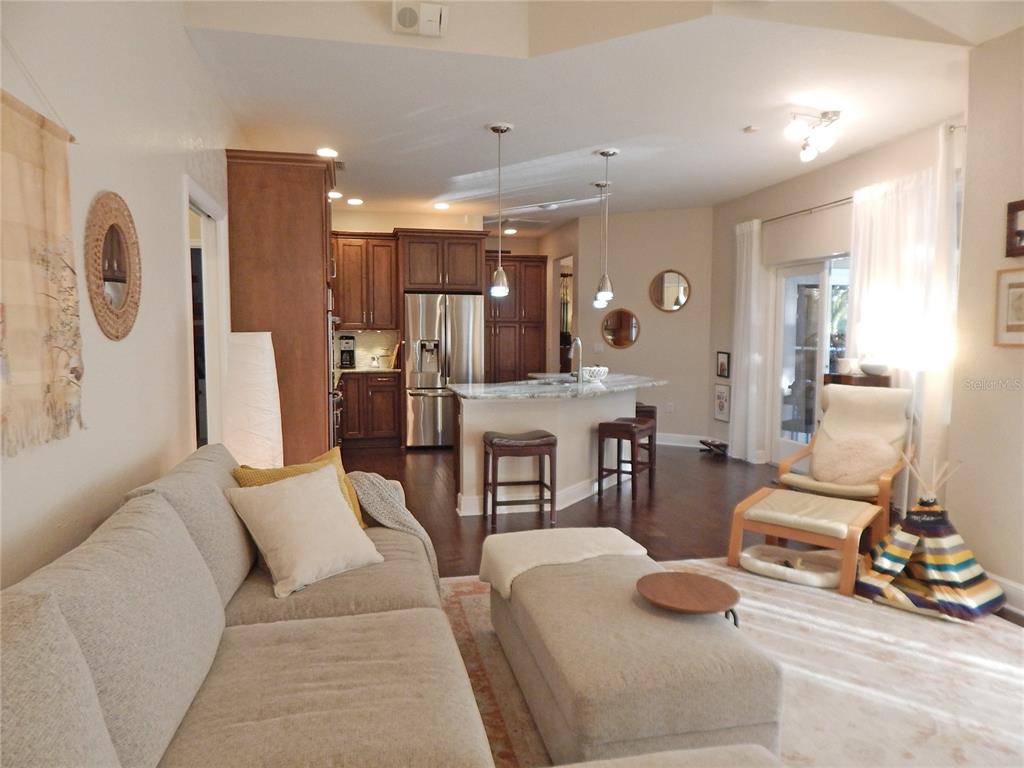 3603 Cypress Meadows Road Tampa, FL 33624 - Photo 13 of 33 a living room with furniture and wooden floor