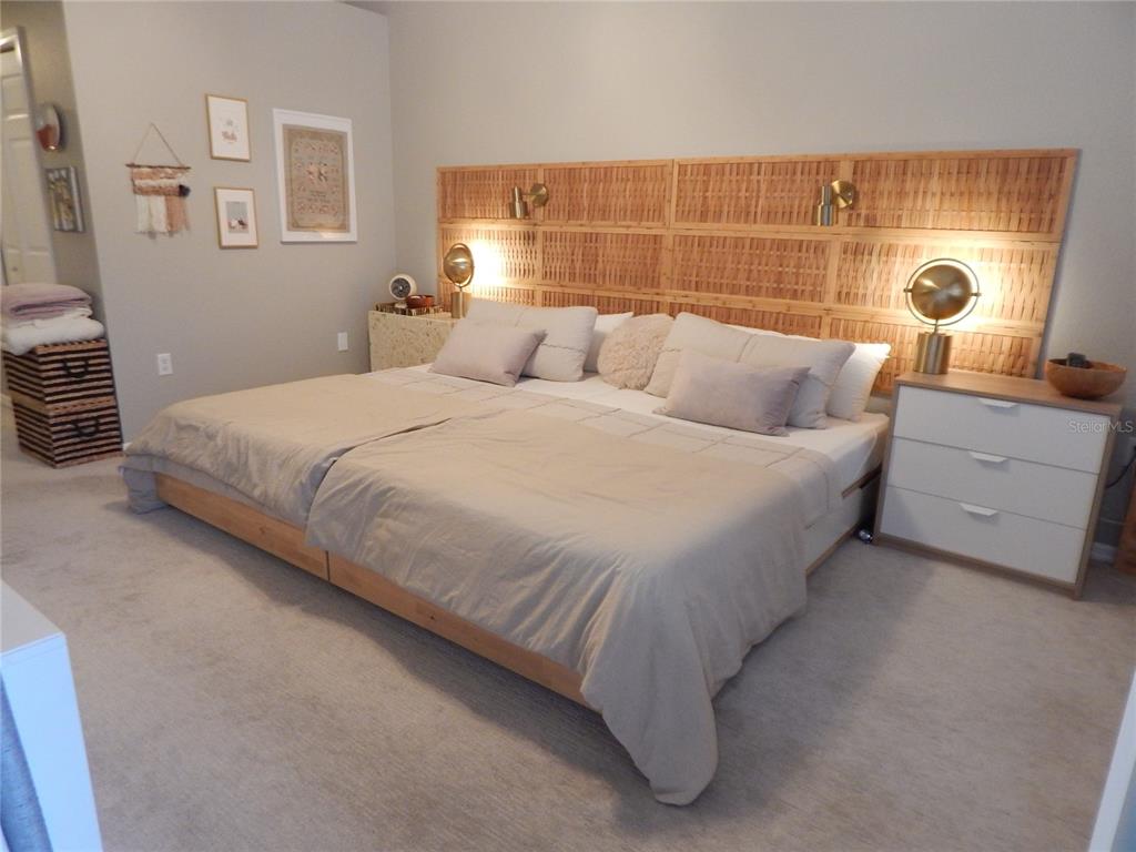 3603 Cypress Meadows Road Tampa, FL 33624 - Photo 15 of 33 a bedroom with a bed and a potted plant