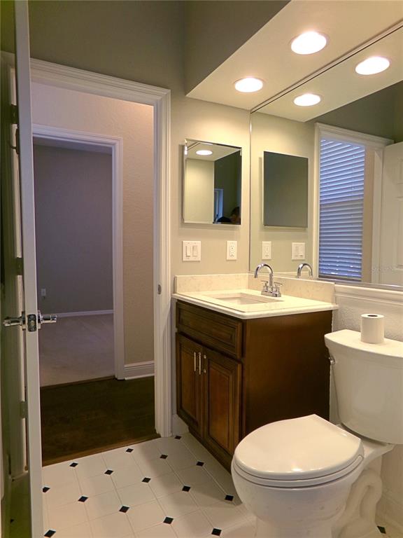 3603 Cypress Meadows Road Tampa, FL 33624 - Photo 16 of 33 a bathroom with a sink a toilet a mirror and shower