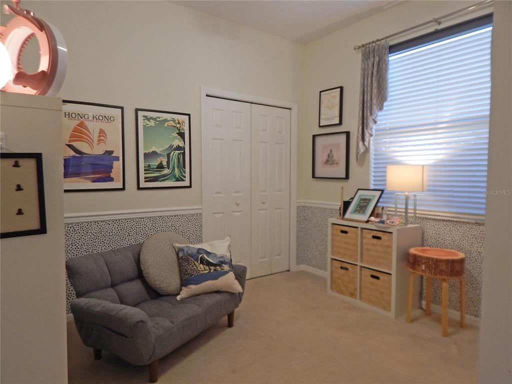 3603 Cypress Meadows Road Tampa, FL 33624 - Photo 22 of 33 a living room with furniture and painting on the wall