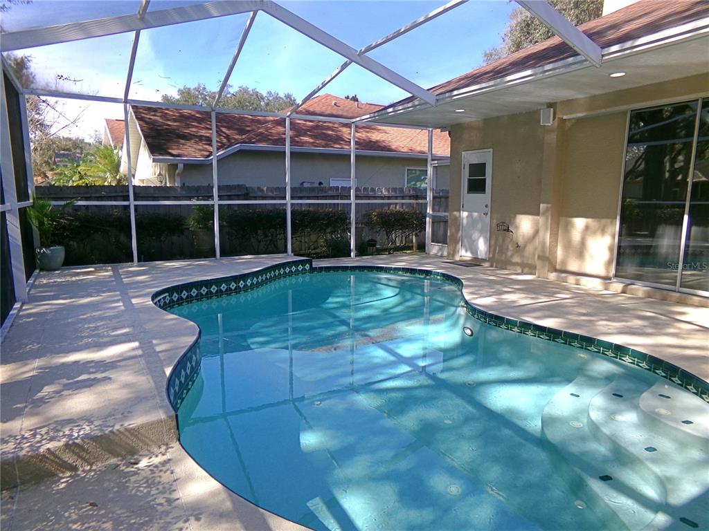 3603 Cypress Meadows Road Tampa, FL 33624 - Photo 29 of 33 a view of a house with backyard and porch