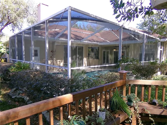 a front view of a house with porch and garden