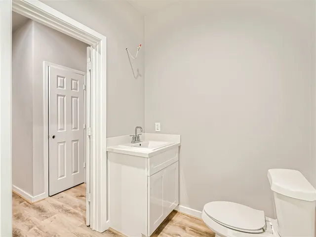 a white toilet sitting next to a bathroom sink