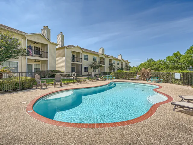 a view of a swimming pool with outdoor seating