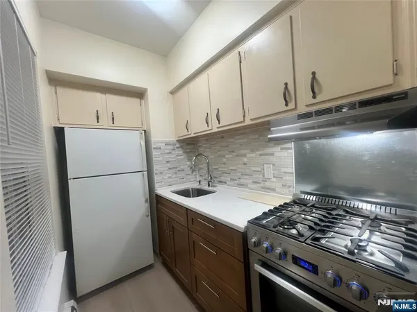 a kitchen with a stove and a refrigerator