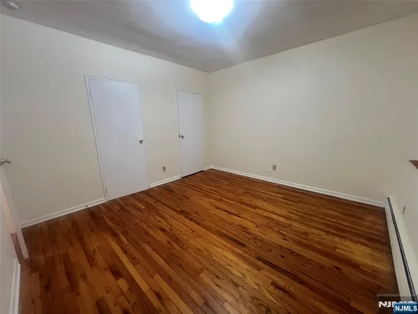 a view of a room with wooden floor