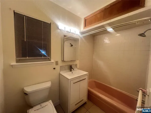 a bathroom with a sink a toilet and a shower