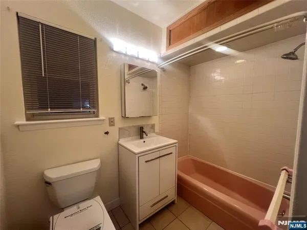 a bathroom with a sink a toilet and a shower