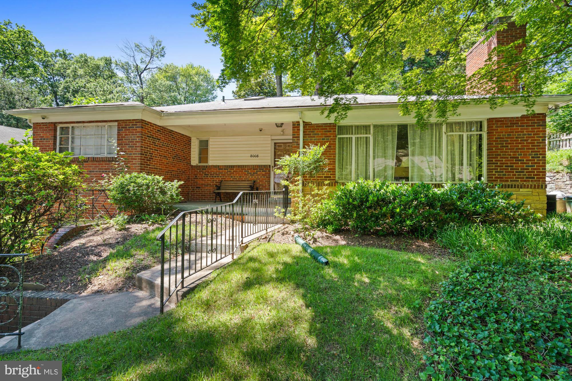 a view of a house with a yard and sitting area
