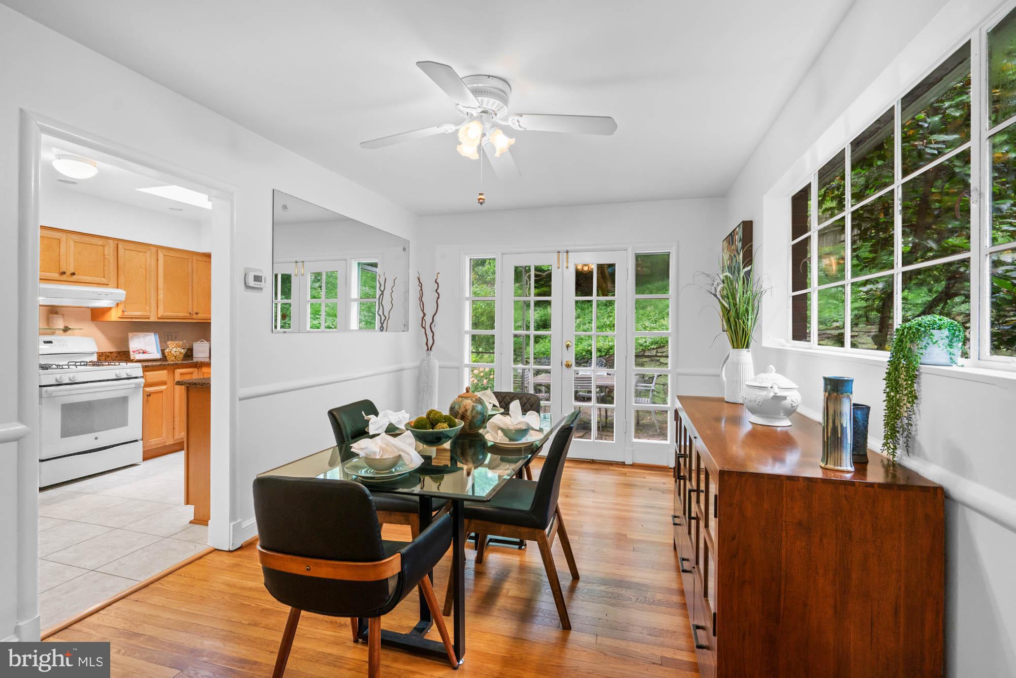 8008 Park Crest Drive Silver Spring, MD 20910 - Photo 20 of 42 a dining room with furniture a chandelier and wooden floor