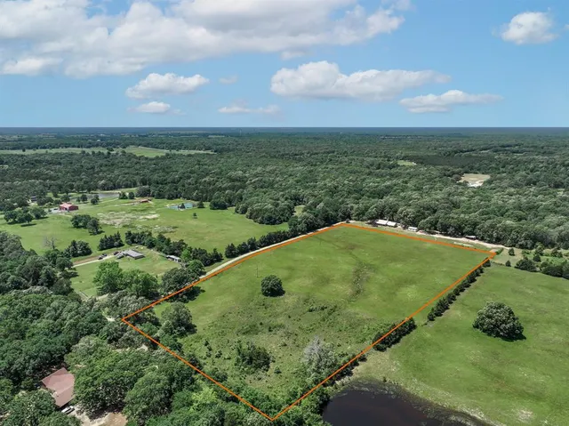 an aerial view of a houses with outdoor space