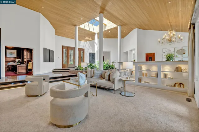 a living room with furniture and a floor to ceiling window