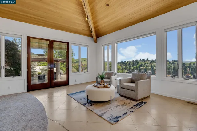 a living room with furniture and flowers