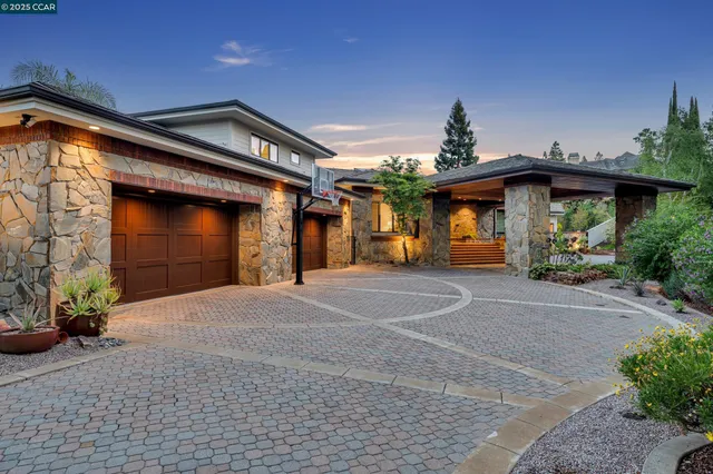 a front view of a house with a yard and a garage